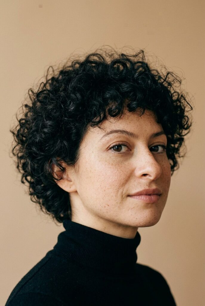 Layered bixie haircut for short curly hair with soft texture and modern shape