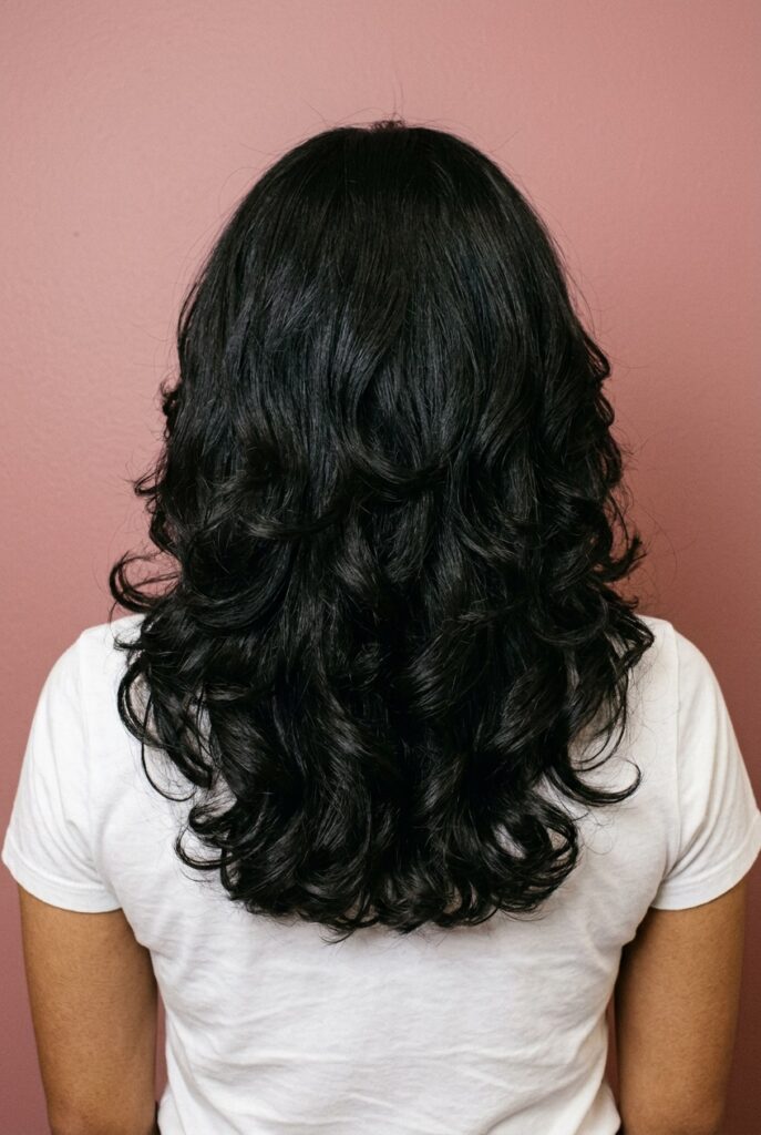 Long haircut with rounded perimeter and soft, healthy ends on woman